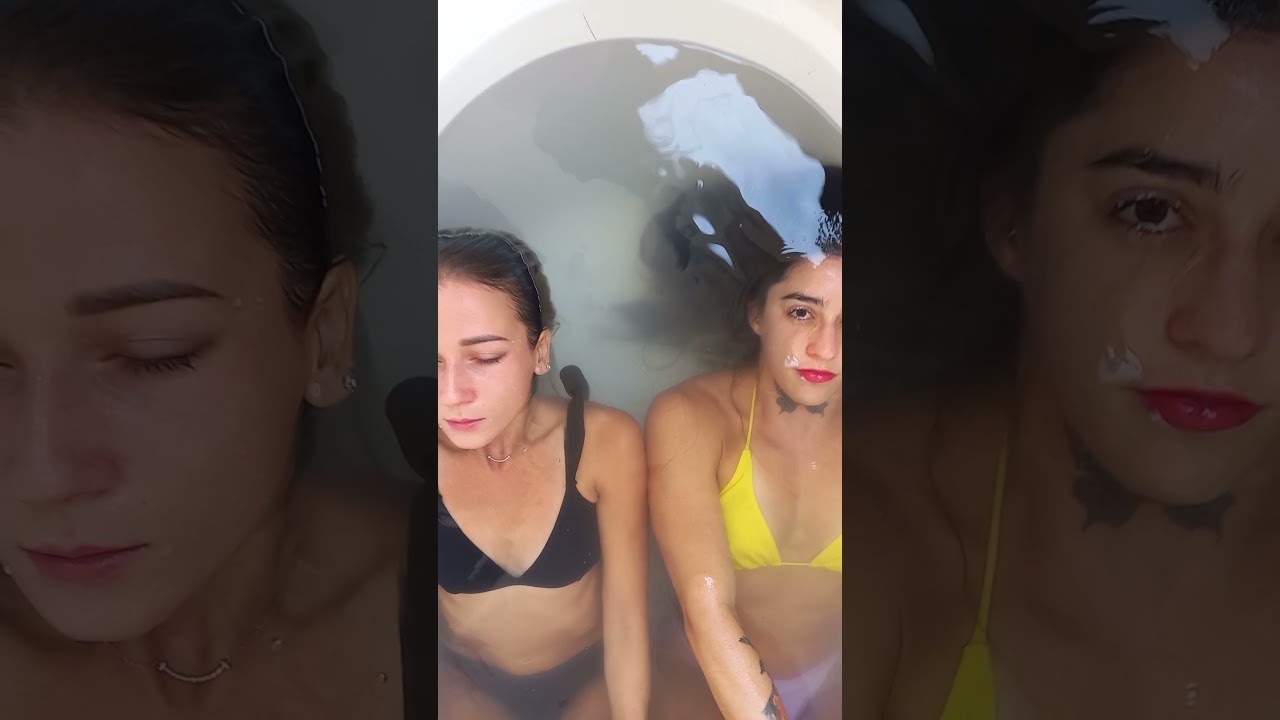 2 girls bathtube close up eyes waterline
