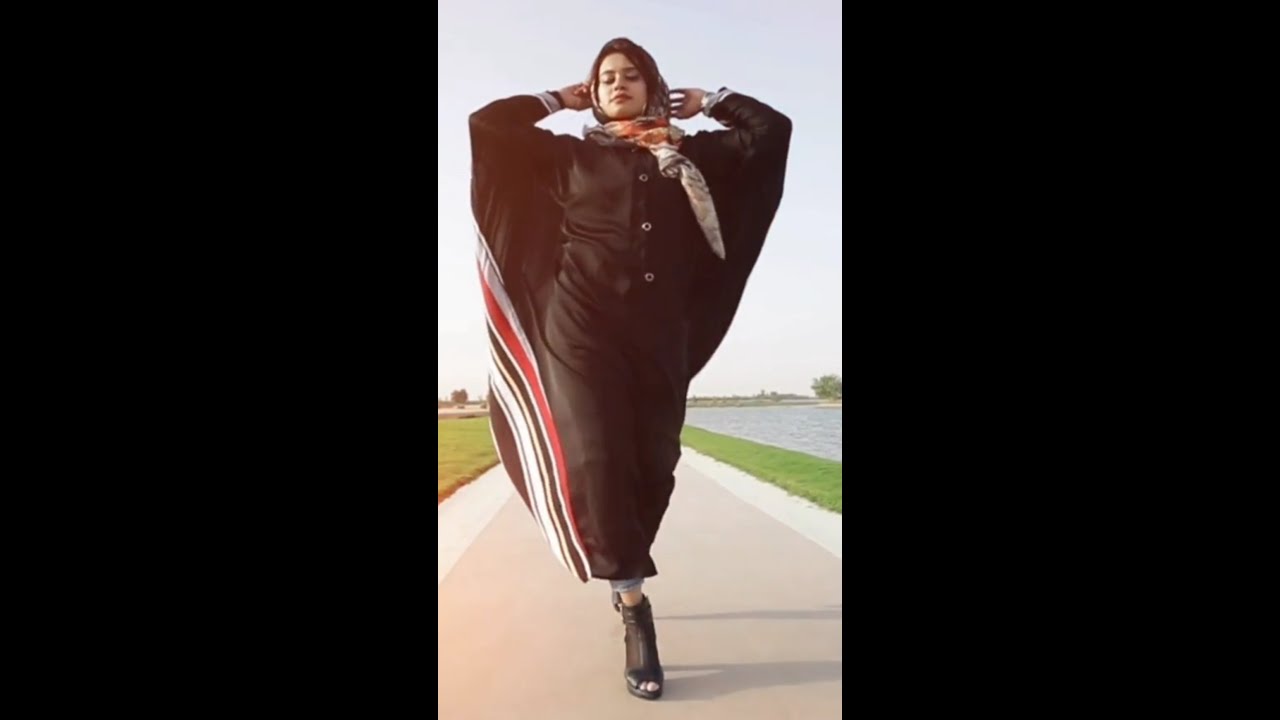 Arabic girl wearing hijab walking down the street like modeling girls