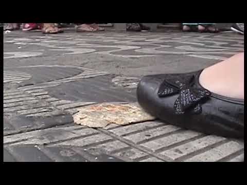 Candid bread crush in city in dirty shoes