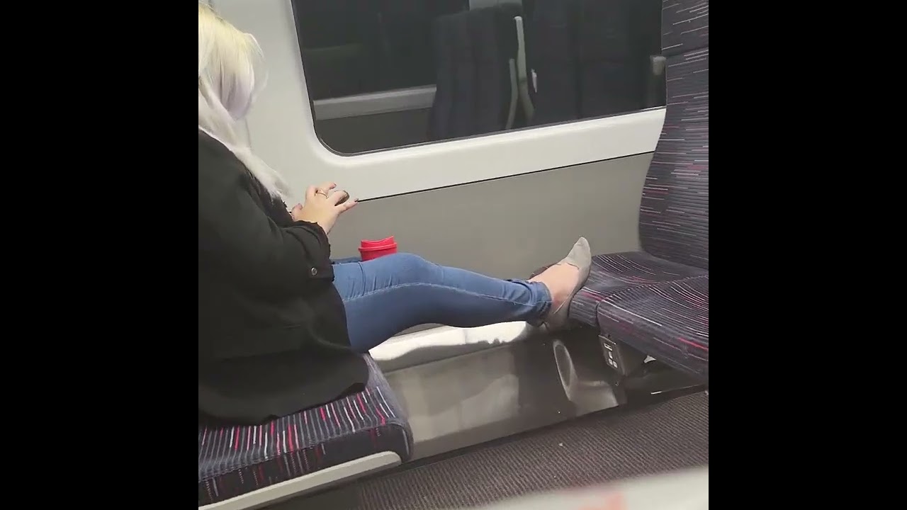 Candid of a cute woman in flats on train.