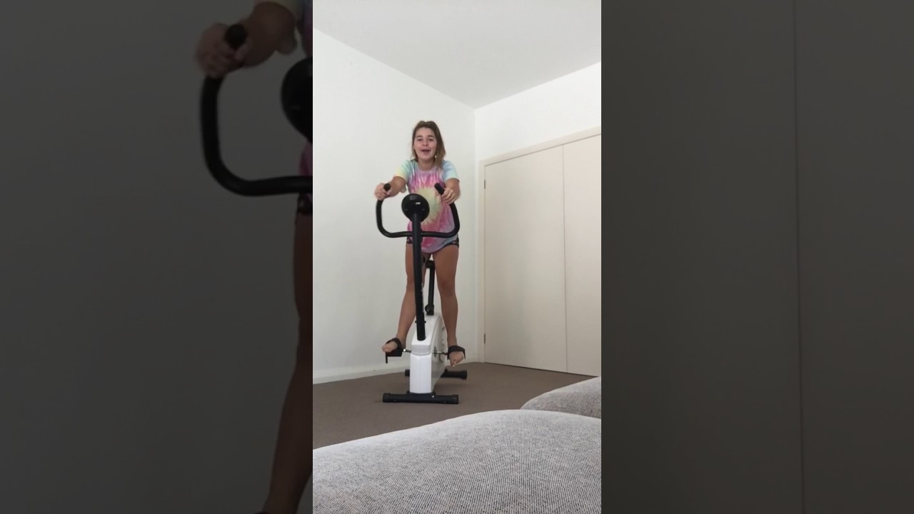 girl falls off exercise bike