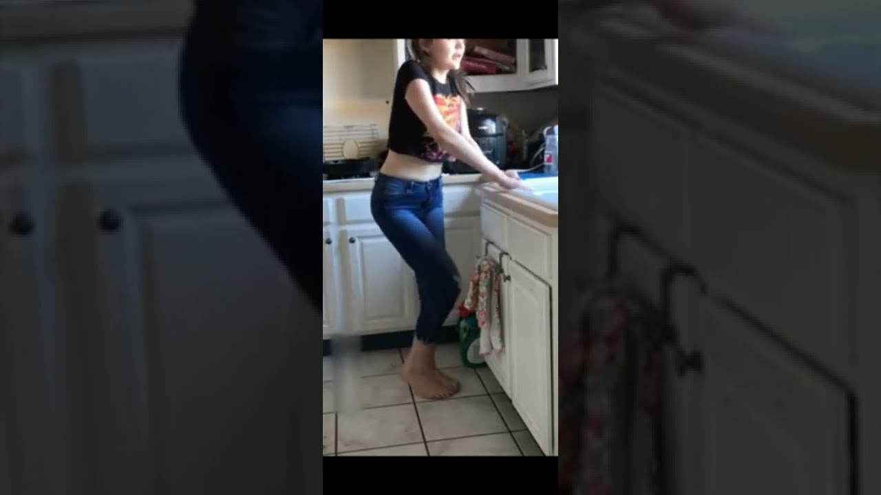 Girl pees pants while doing dishes Barefoot