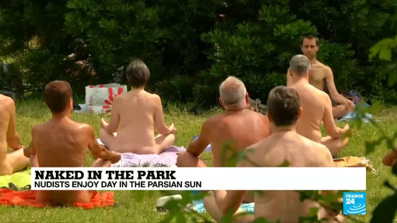 Paris: Naked in a park, Parisian nudists enjoy a hot day in the sun