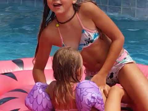 The 4 little girls swimming in the pool