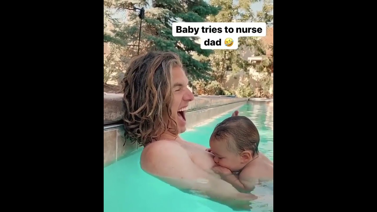 The baby tries drinking milk from his Dad. 😂😂😂
