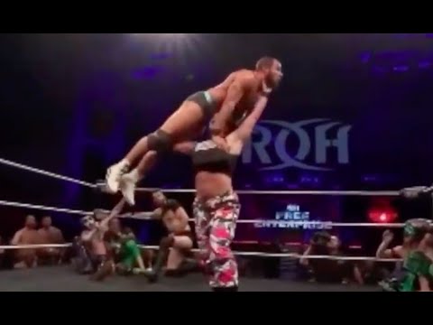Women wrestlers pressing men overhead.